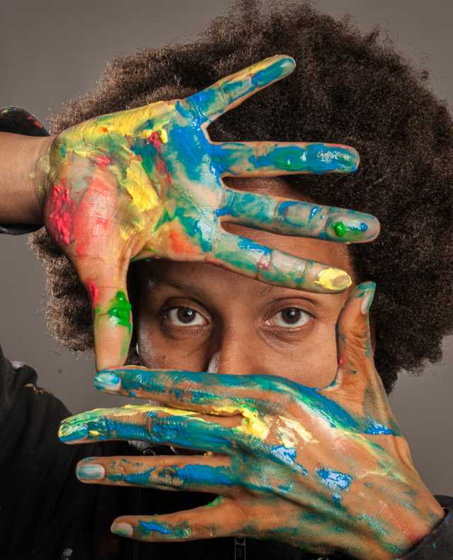 black-woman-with-her-hands-painted-gray